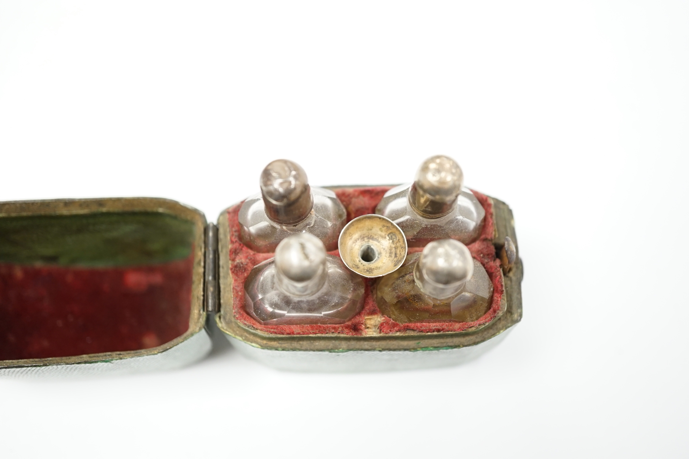 A set of four Dutch white metal mounted scent bottles, with funnel, housed in a shagreen case with hinged cover, case height 69mm.